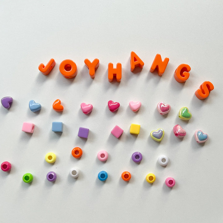 Colorful acrylic alphabet letter beads for personalized jewelry making, compatible with various DIY craft strings.