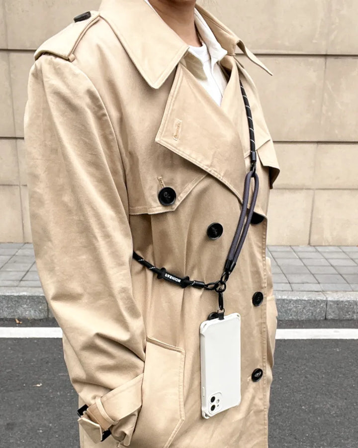 Stylish double rope black nylon phone strap worn as a crossbody accessory for hands-free travel#color_black