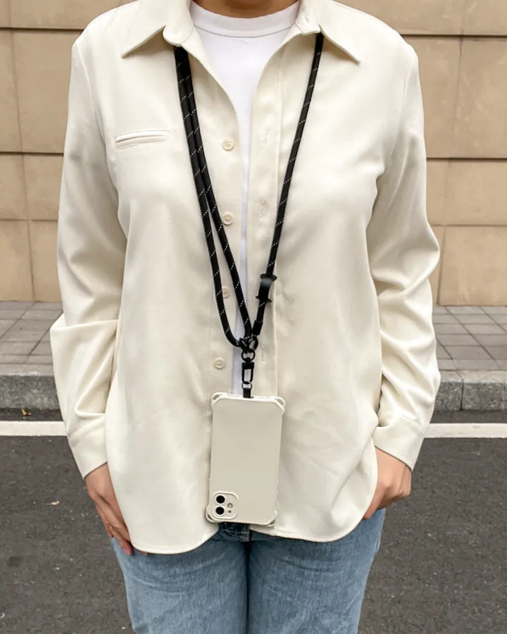 Black phone lanyard styled with everyday clothing, offering practical hands free use without visual distraction#color_black