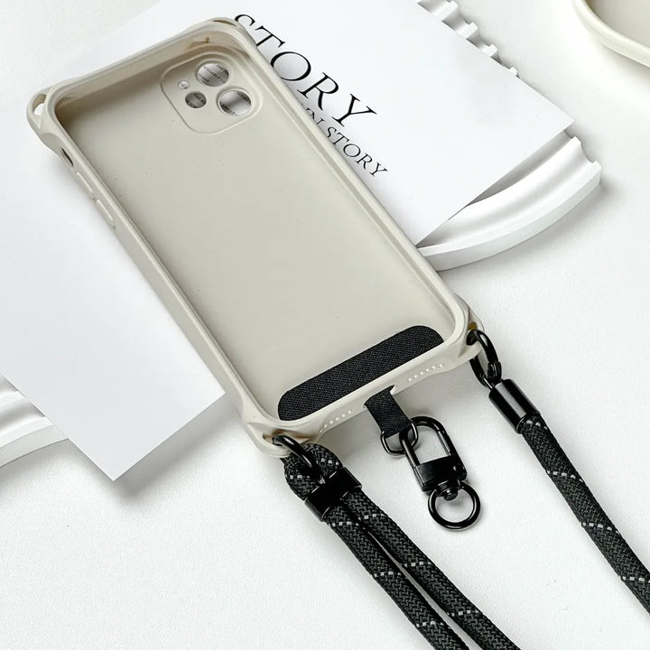 Connection detail of black phone strap attached to phone case, showing secure and stable phone support#color_black