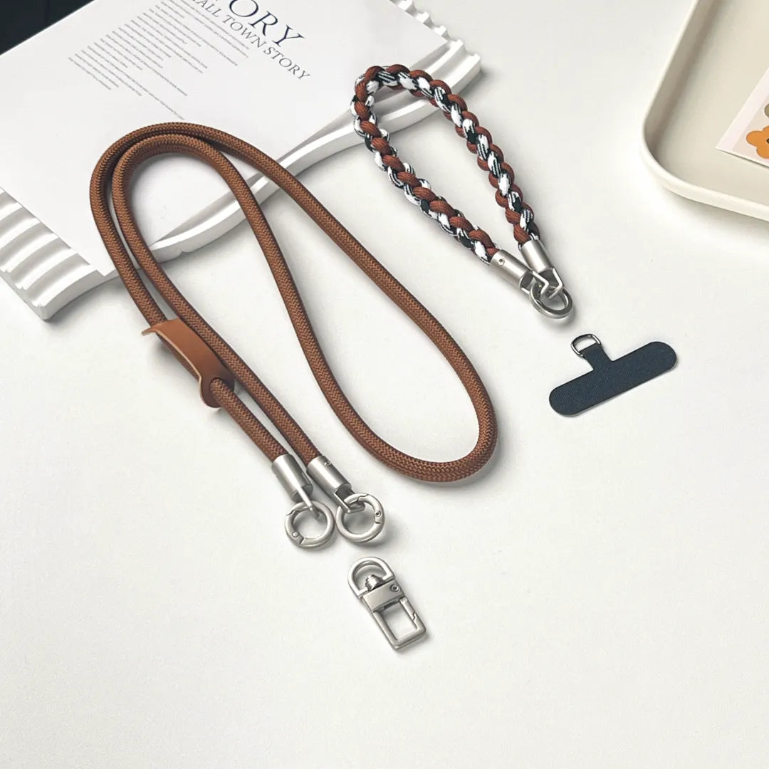 Durable brown leather phone leash in a crossbody length for maximum security and style#color_brown