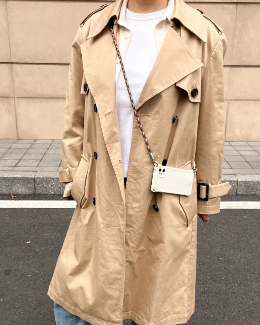 Sophisticated outdoor styling featuring a brown and white crossbody phone lanyard#color_brown