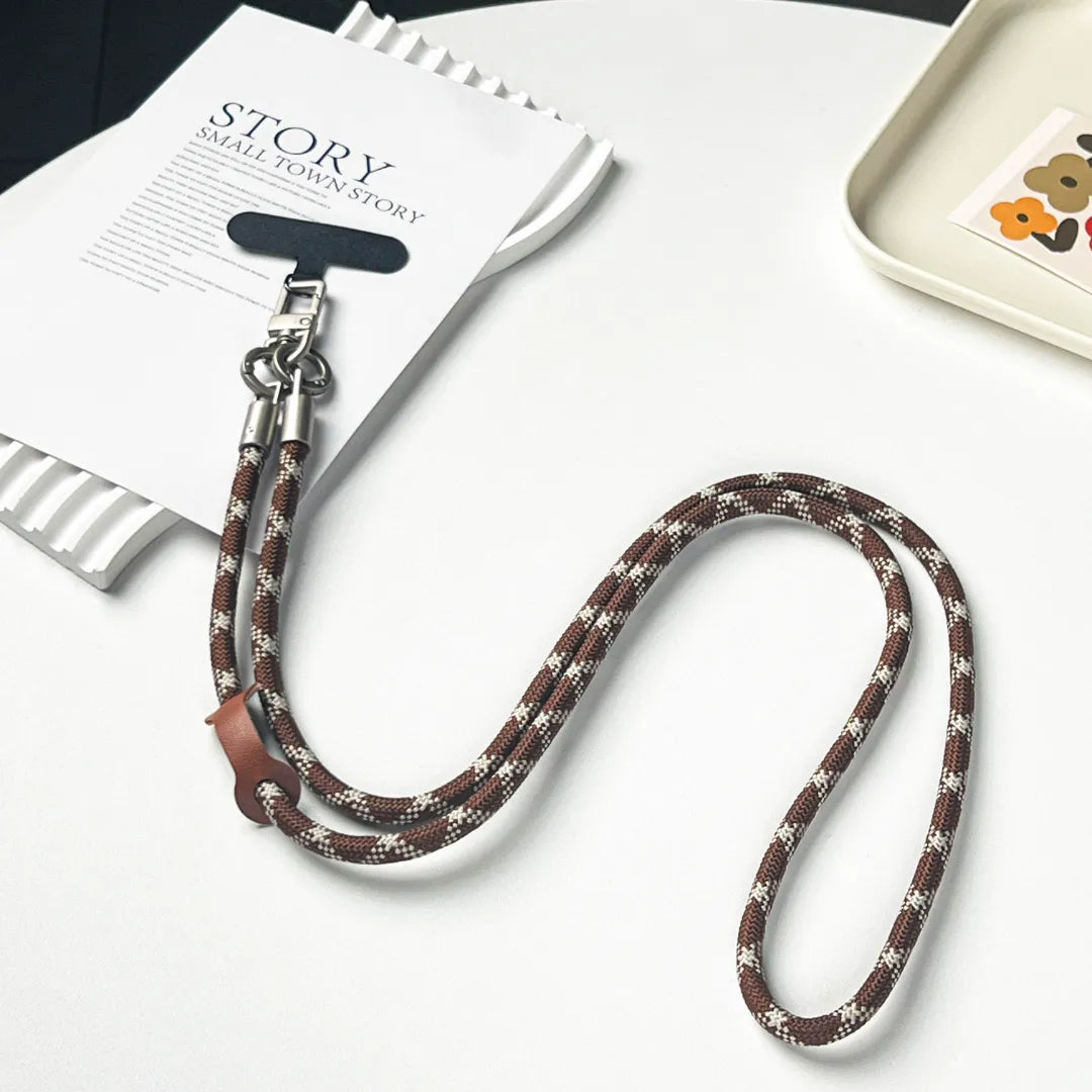 Detailed view of the premium gold clasp on a brown and white patterned phone lanyard#color_brown