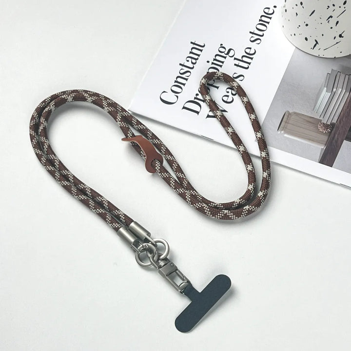 Stylish brown and white pattern leather phone lanyard in a comfortable crossbody style#color_brown