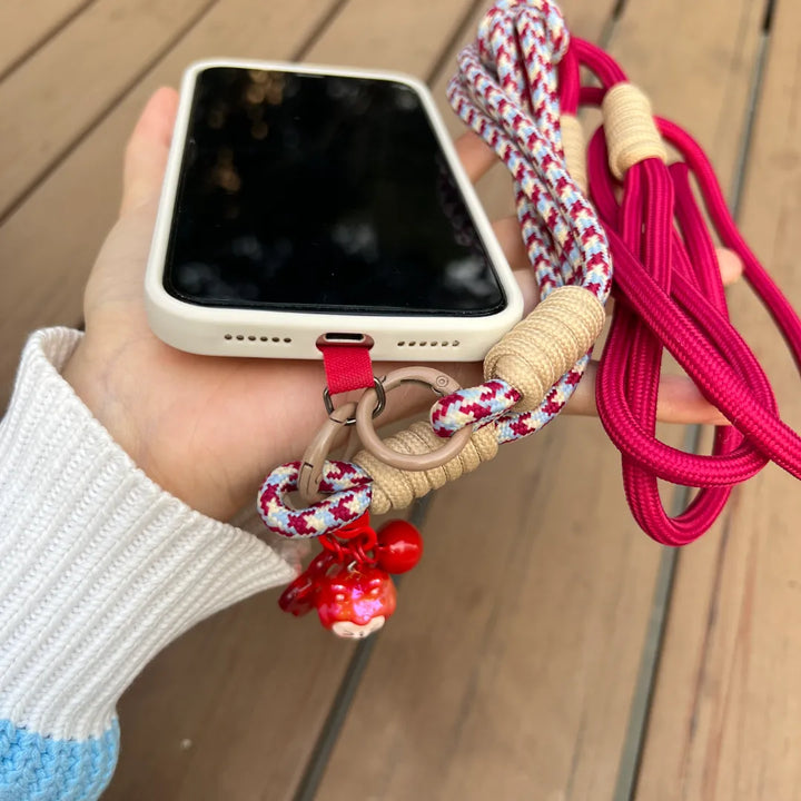 Crossbody phone strap shown in hands free daily use scenario, keeping the phone secure and accessible while walking#color_red