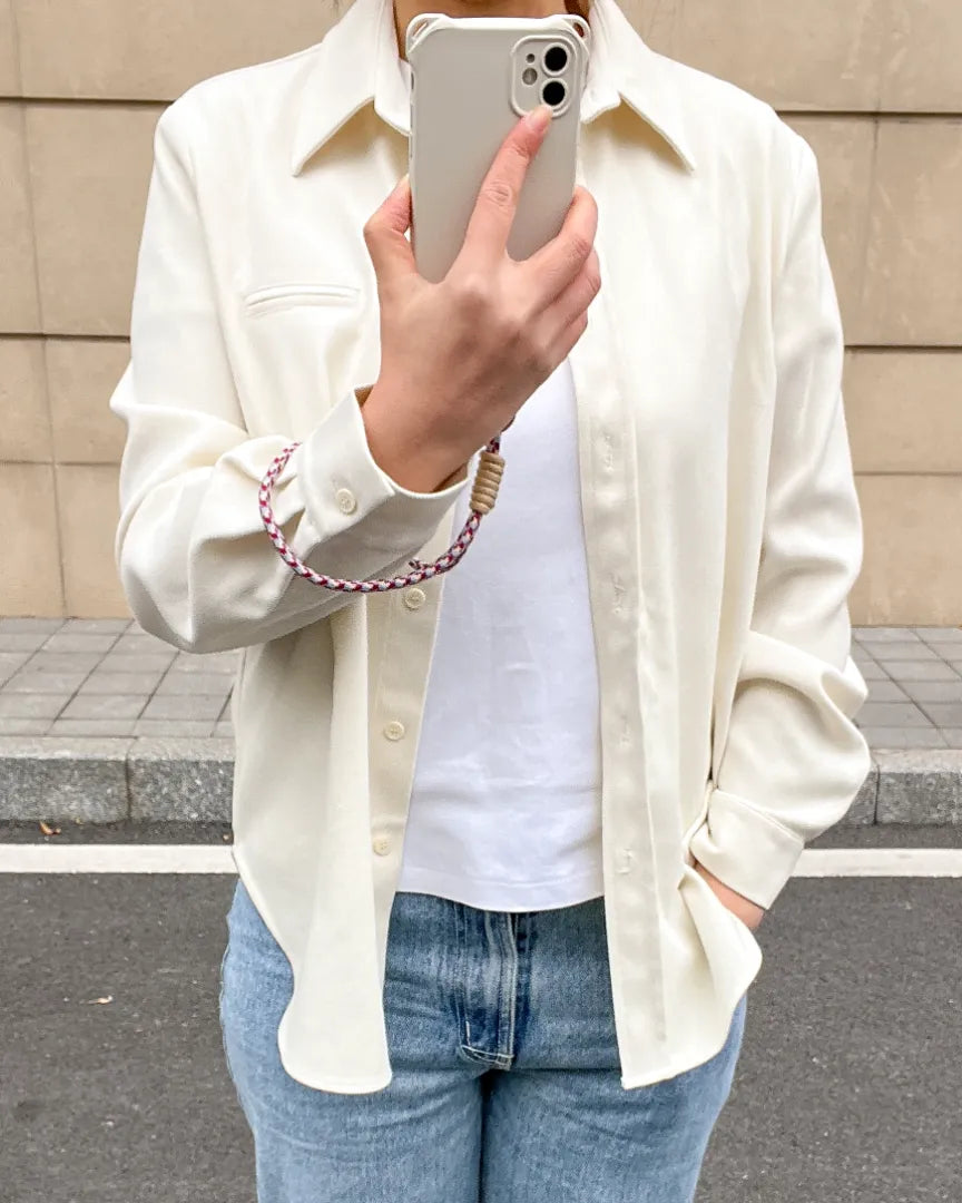 Crossbody phone strap paired with modern outfit, offering hands free carrying for commuting and daily activities#color_red