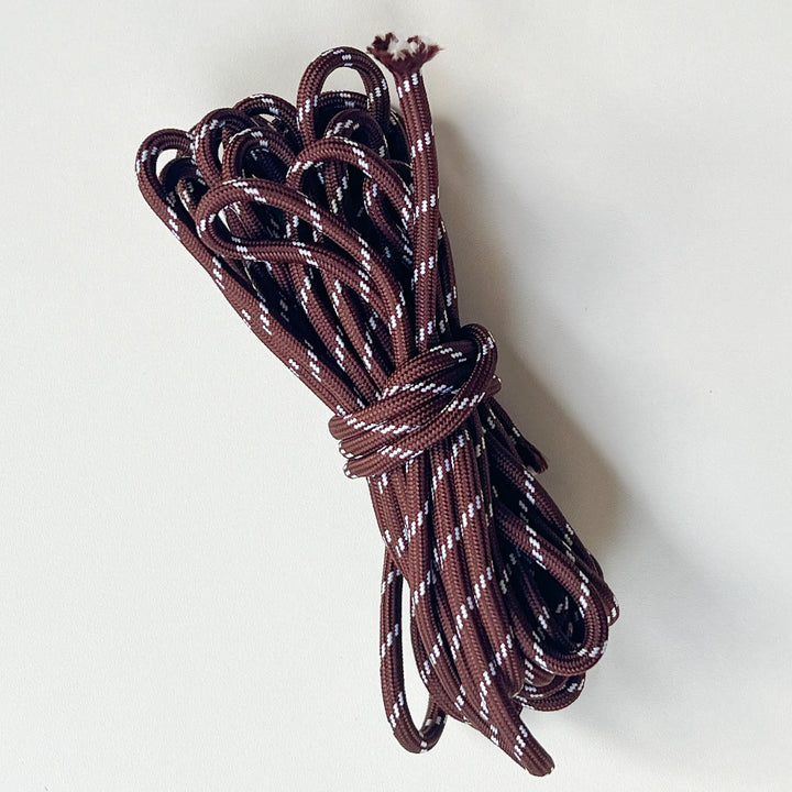 Heavy-duty dark brown paracord braided nylon rope, high-strength material for outdoor survival and DIY lanyards.
