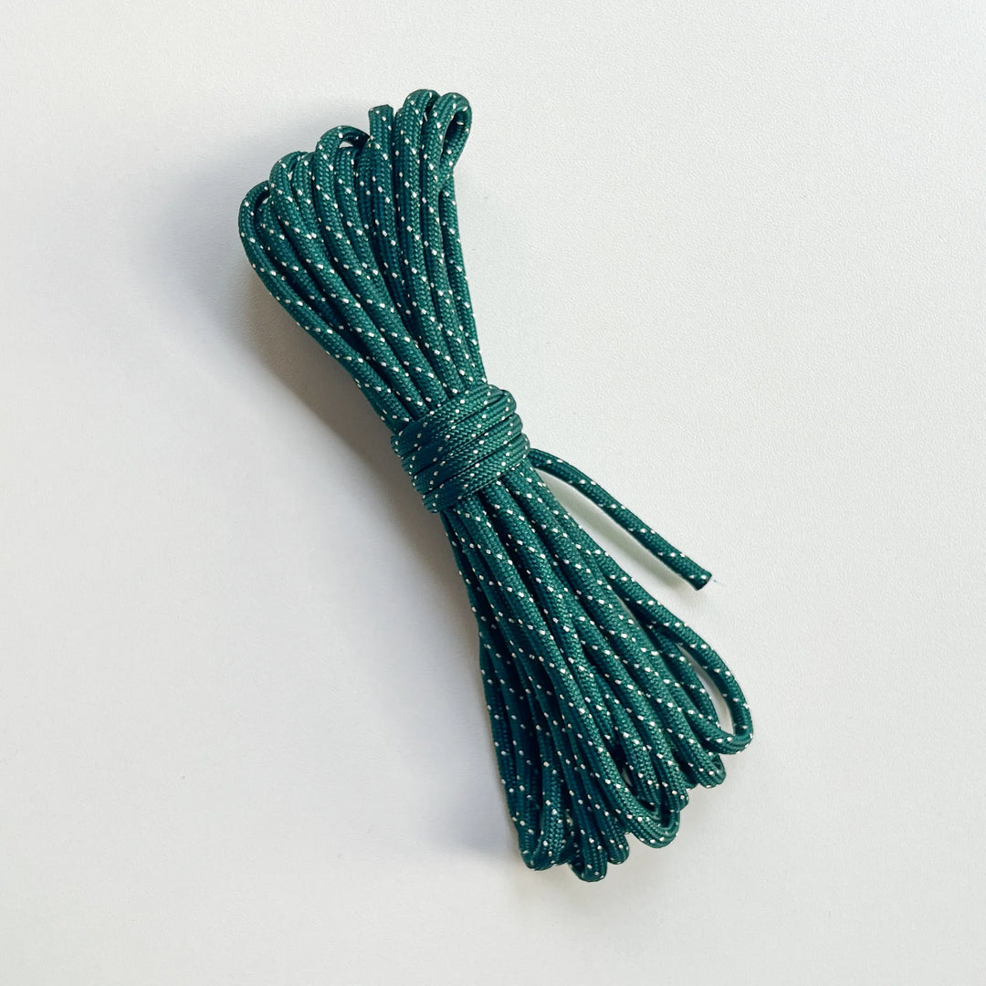 Deep forest green braided string, reinforced stitching quality for long-lasting outdoor use and decorative knotting.