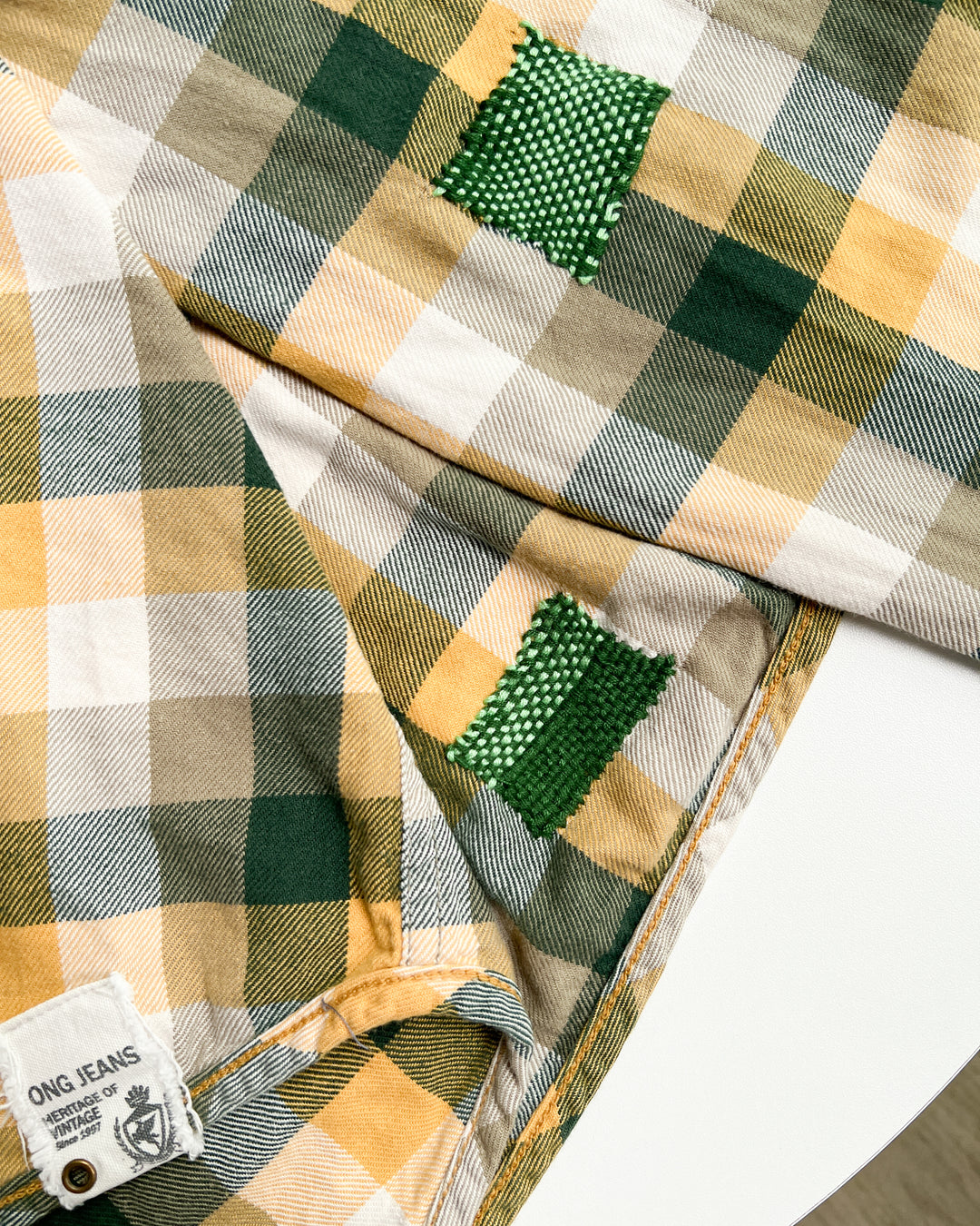 Repairing holes in plaid fabric using weaving loom tool example