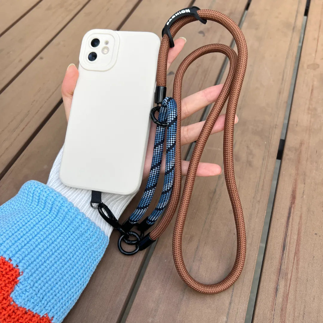 Close up shot of a hand holding a phone with a navy blue braided leather wrist strap#color_brown
