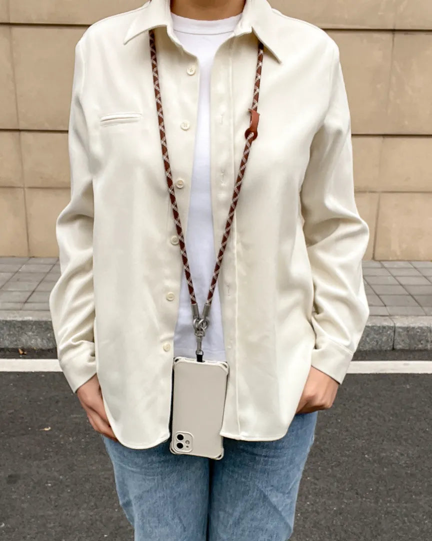 Long brown and white phone lanyard worn crossbody for a fashionable hands-free lifestyle#color_brown
