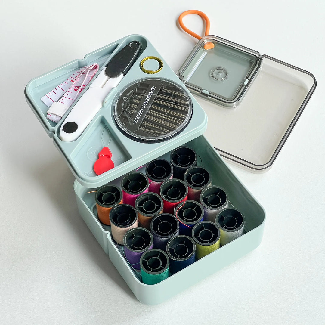 Mint blue mini sewing organizer box including essential mending tools, a sweet and practical gift for handmade enthusiasts.
