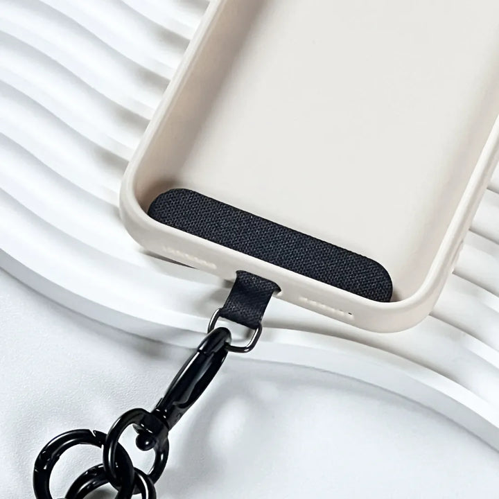 Durable navy blue phone tether tab with a strong metal ring for secure strap connection#color_brown