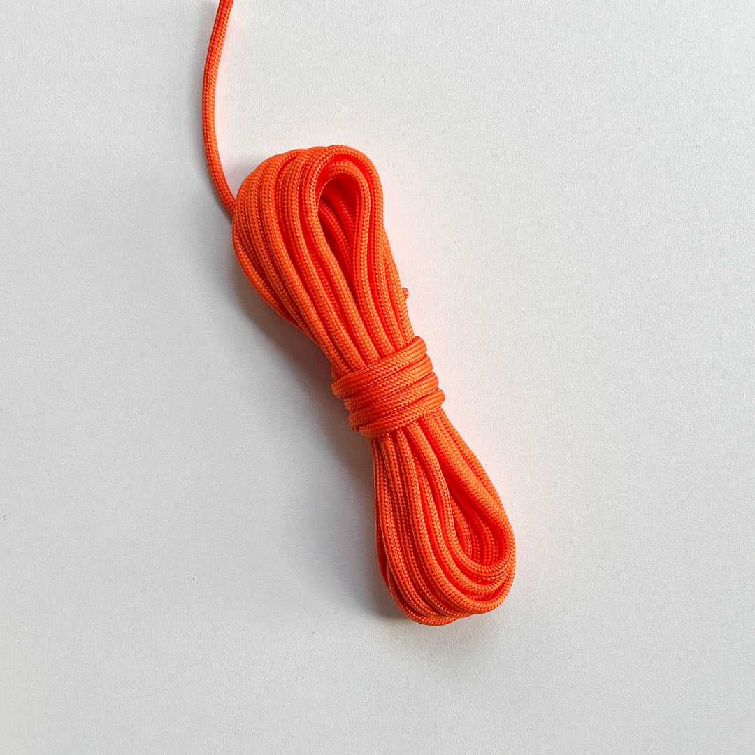 Bright orange nylon paracord braided cord, high-density material suitable for making heavy-duty outdoor lanyards.