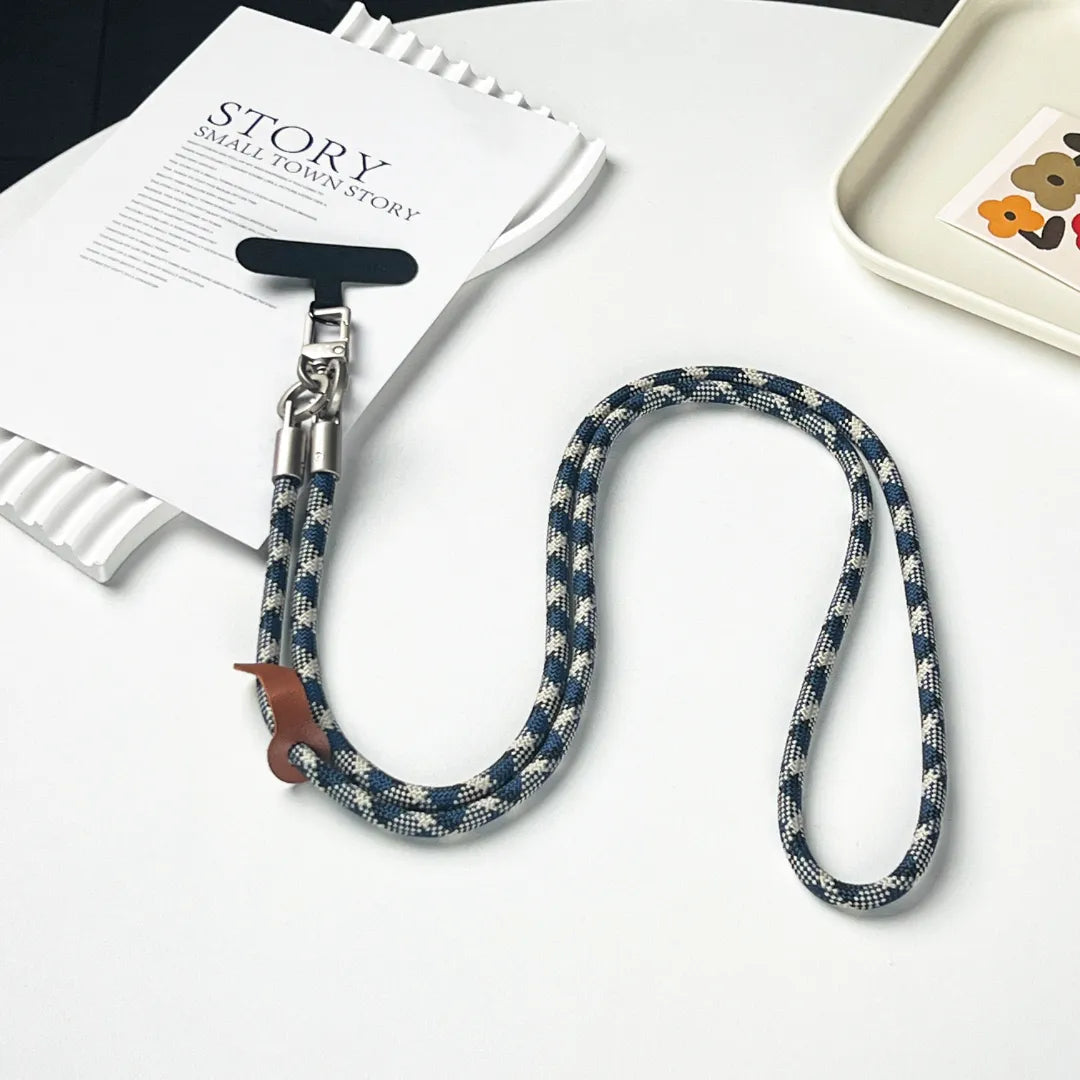 Detailed view of the premium gold clasp on a patterned braided leather phone strap#color_blue