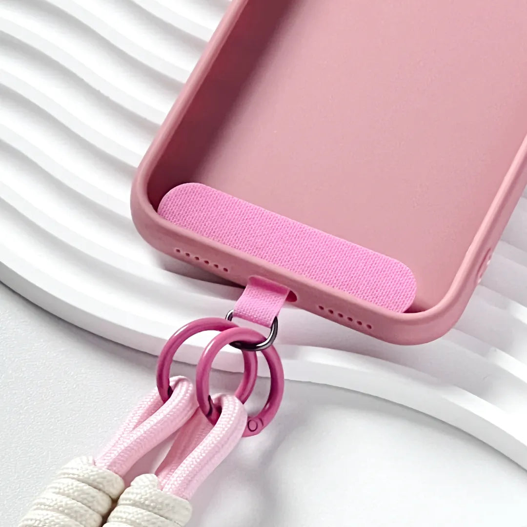Phone case with pink strap attached, demonstrating hands free carrying solution with soft color styling#color_pink
