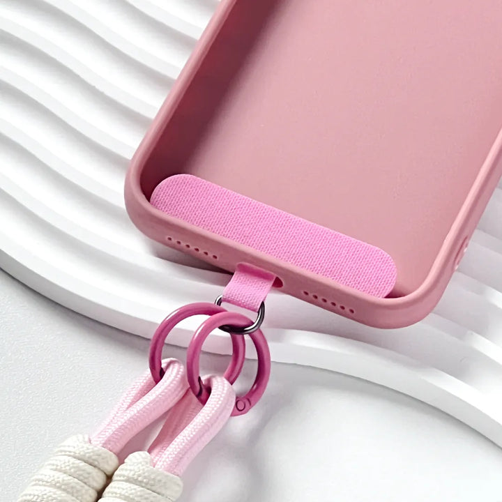 Phone case with pink strap attached, demonstrating hands free carrying solution with soft color styling#color_pink