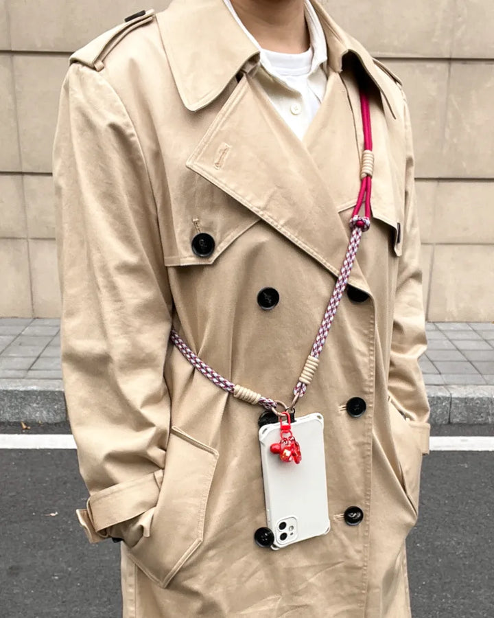 Phone lanyard styled with everyday outfit, showing simple fashion pairing and hands free phone convenience#color_red