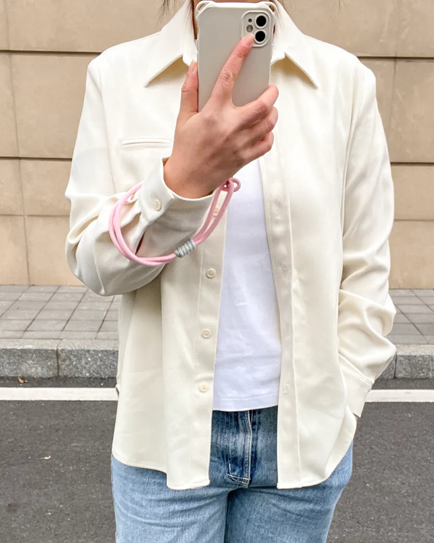Pink phone wrist strap displayed in one hand use, helping prevent drops while offering soft and comfortable handling#color_pink