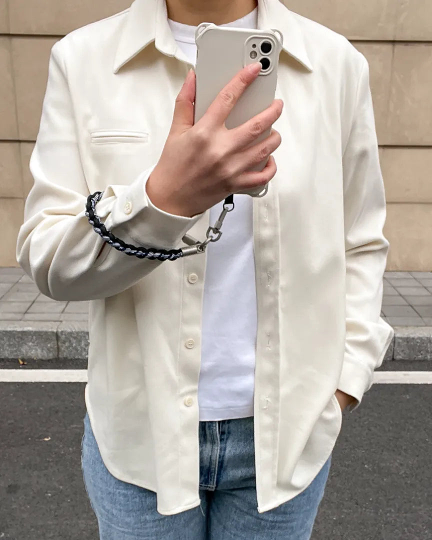 Rugged phone wrist strap displayed in one hand use, helping prevent drops while offering strong grip and control#color_black