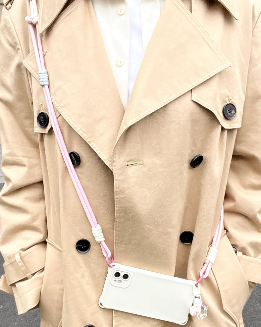 Pink phone lanyard worn as a fashion accessory, providing secure phone holding without overpowering the outfit#color_pink