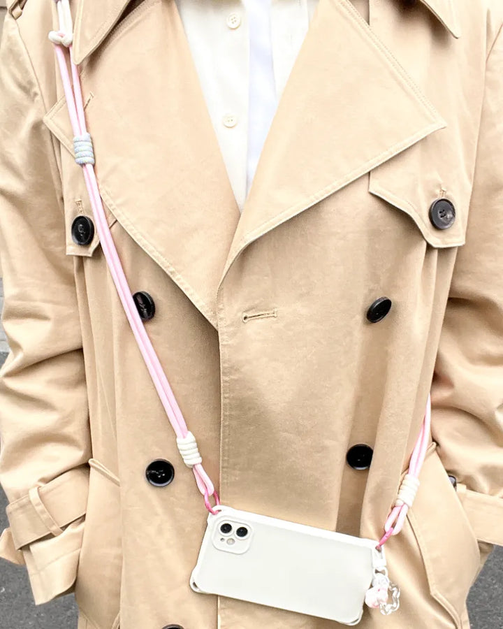 Pink phone lanyard worn as a fashion accessory, providing secure phone holding without overpowering the outfit#color_pink