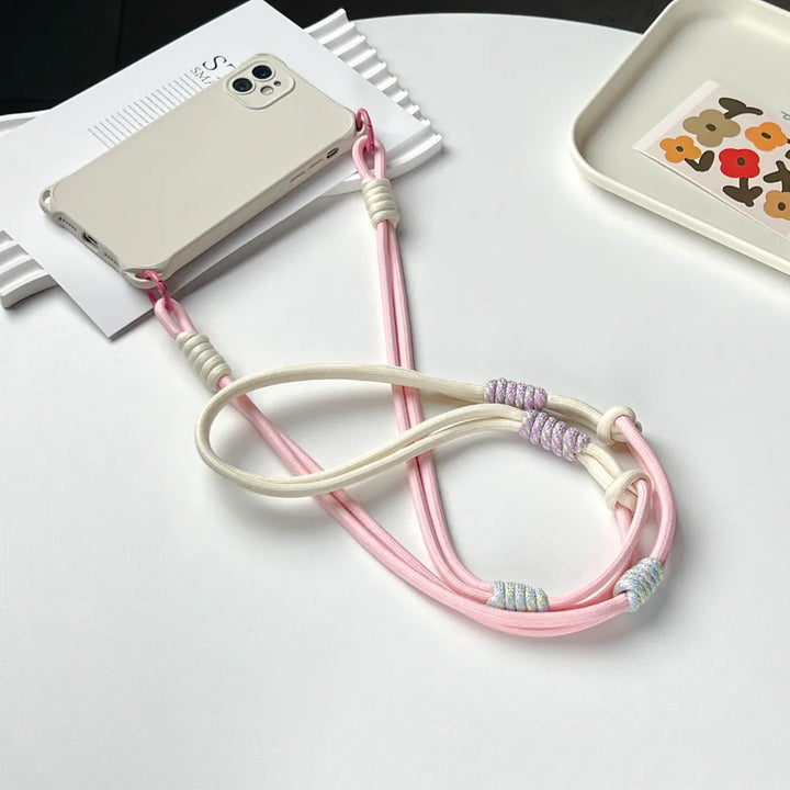 Pink phone strap connection detail designed to reduce drops while maintaining a lightweight structure#color_pink