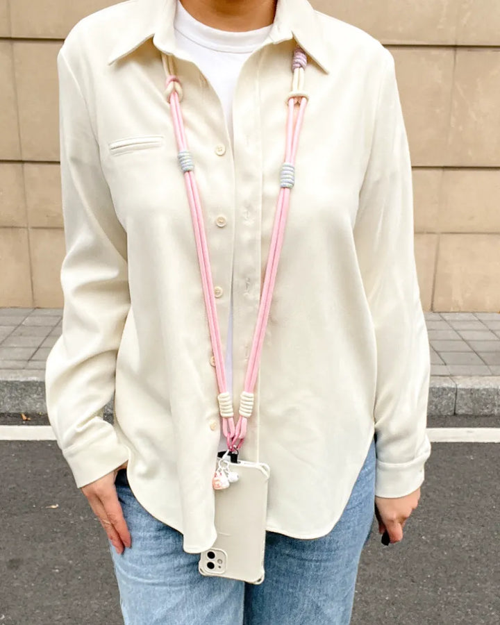 Pink phone strap paired with casual clothing, showing lightweight design and relaxed daily fashion use#color_pink