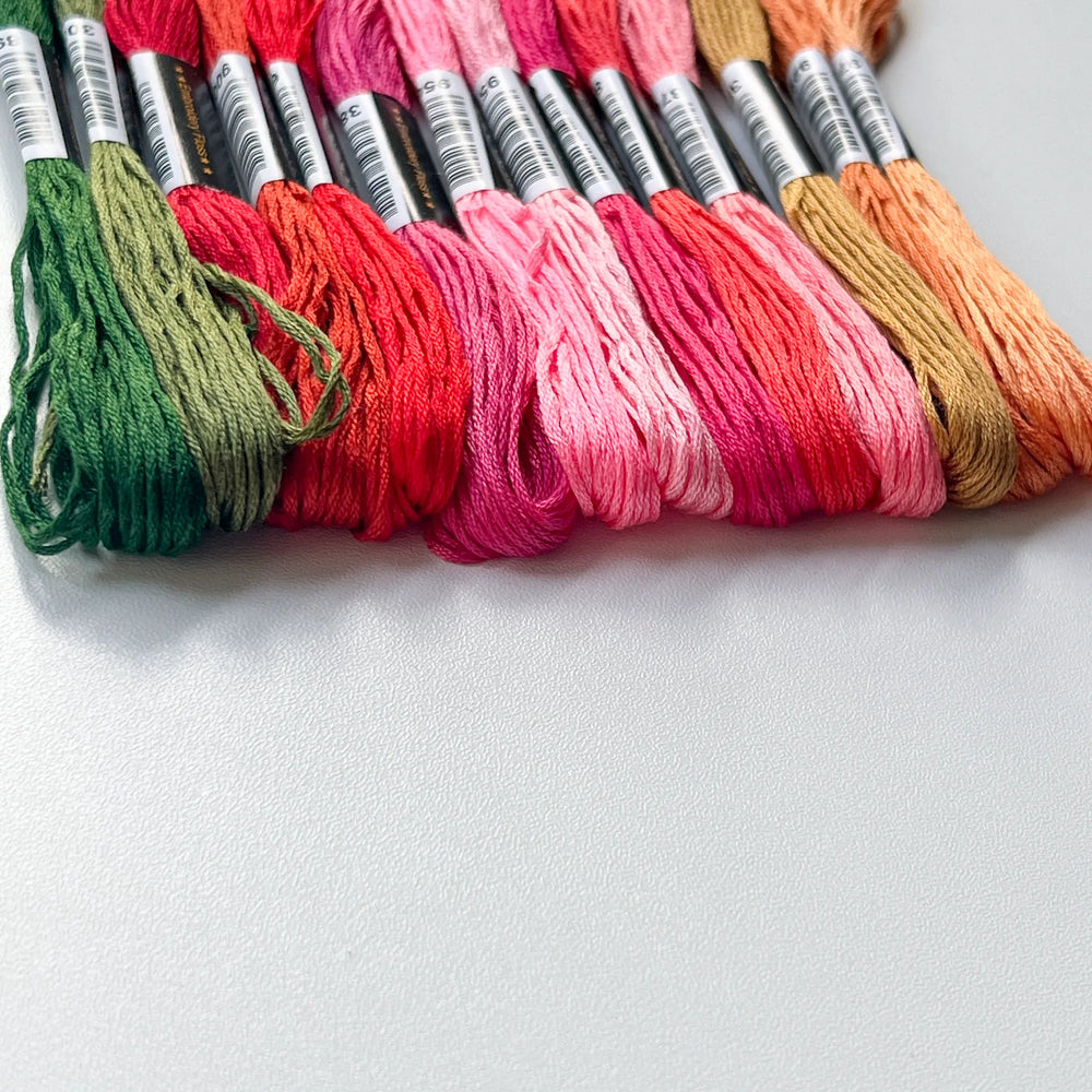 A row of rainbow embroidery floss cotton skeins, ultra-soft and skin-friendly threads for cross stitch and friendship bracelets.