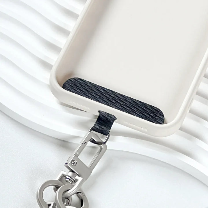 Close up image of rugged phone strap connector detail highlighting reinforced structure and secure attachment#color_black