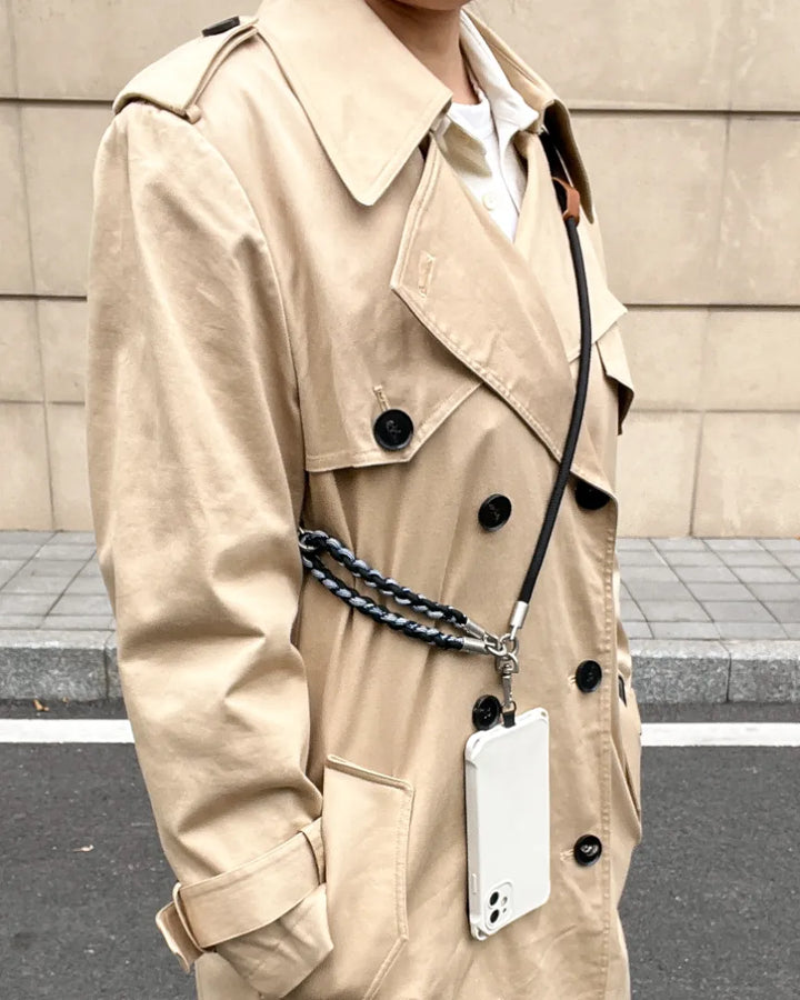 Rugged phone strap worn with minimalist commuter outfit, emphasizing durability and hands free phone carrying#color_black