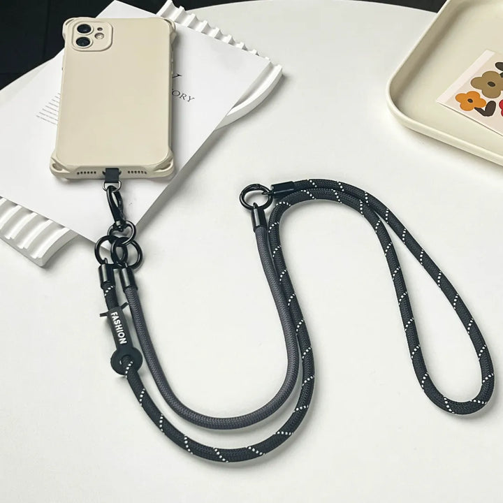 Short black phone charm strap made of exquisite leather braid for stylish wrist carryingl#color_black