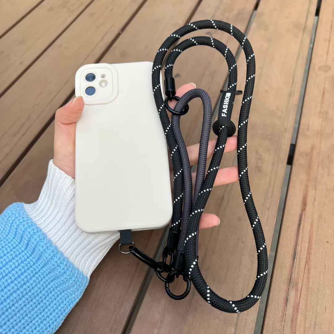 Close up view of a hand holding a smartphone with a classic black braided leather wrist strapl#color_black