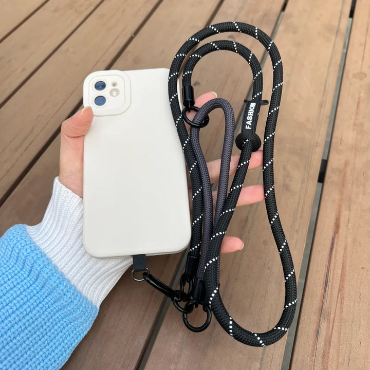 Close up view of a hand holding a smartphone with a classic black braided leather wrist strapl#color_black