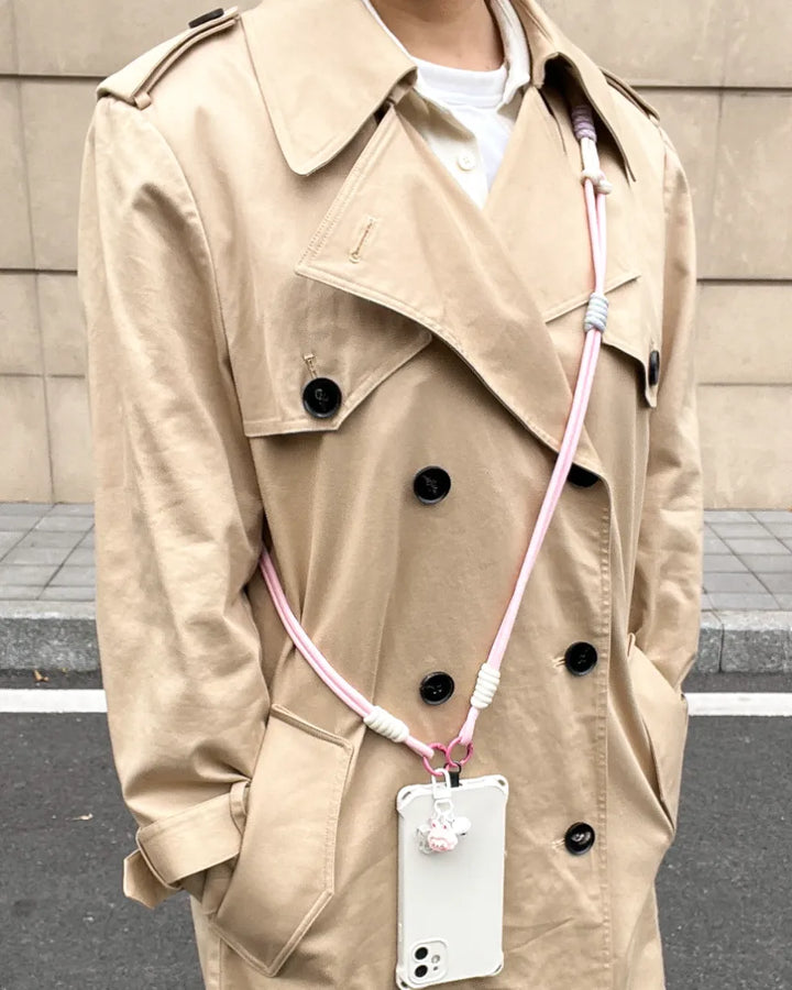 Soft color phone strap worn with everyday outfit, adding subtle style while keeping the phone accessible#color_pink