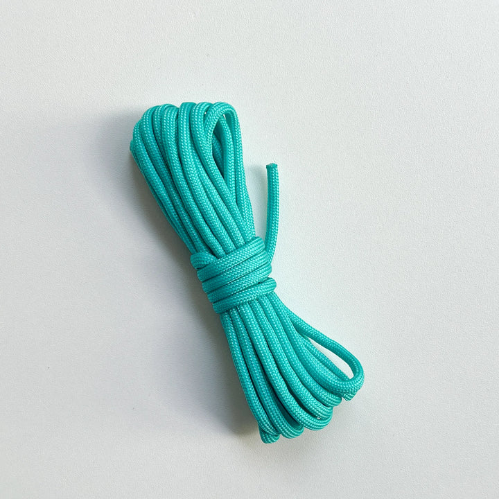 Soft teal cotton embroidery thread skein, skin-friendly material for cross stitch and handmade friendship bracelets.