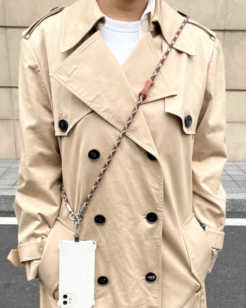 Trendy women's phone lanyard in brown and white for a functional and fashionable outfit#color_brown