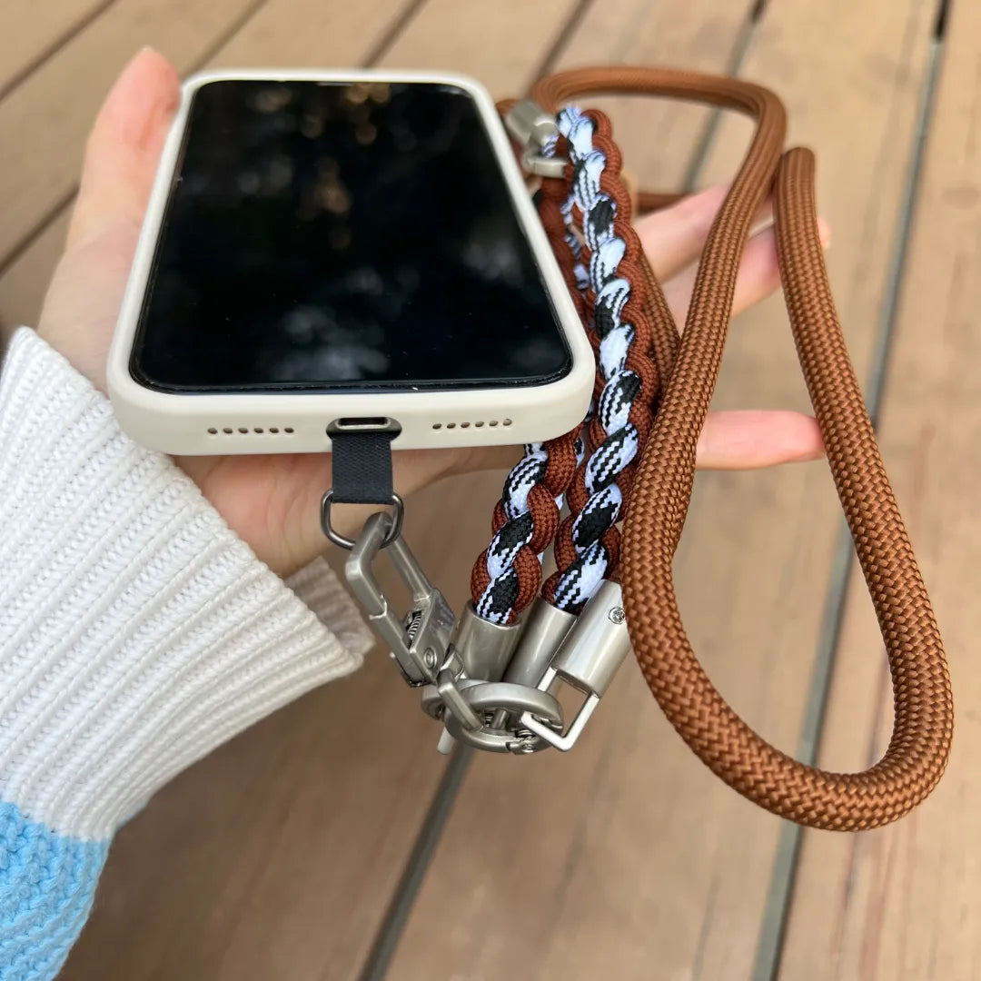 Secure grip provided by a stylish brown leather wrist phone strap for easy daily mobile use#color_brown